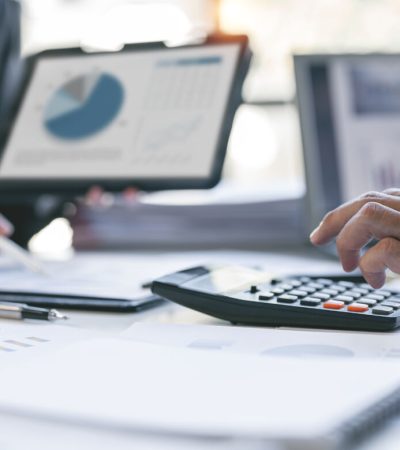 Cropped shot of two coworkers working together in boardroom, brainstorming, discussing and analyzing business strategy.