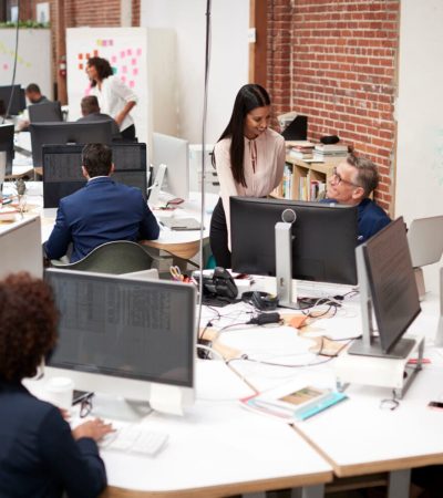 Business Team Working At Desks In Modern Open Plan Office