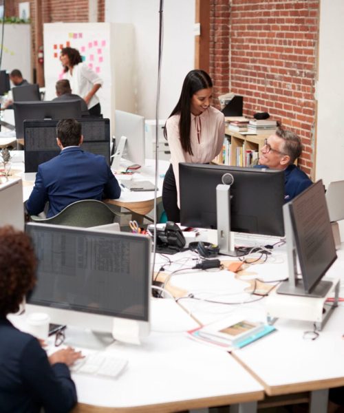 Business Team Working At Desks In Modern Open Plan Office
