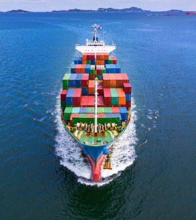 Aerial view container ship carrying container in import export business logistic and transportation of international by container ship in the open sea.