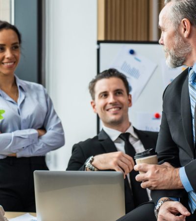 Group of multi-Ethnic businessman and businesswoman working in office. Attractive employee brainstorm and meeting as team, plan and discuss project in workplace. Corporate of modern colleagues concept