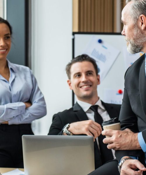 Group of multi-Ethnic businessman and businesswoman working in office. Attractive employee brainstorm and meeting as team, plan and discuss project in workplace. Corporate of modern colleagues concept