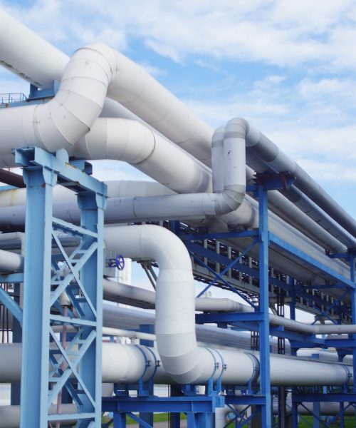 GRUPO INMSA A closeup of industrial pipelines around a factor on a sunny day