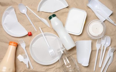 plastic waste from life on the background of brown kraft paper, environmental pollution, top view