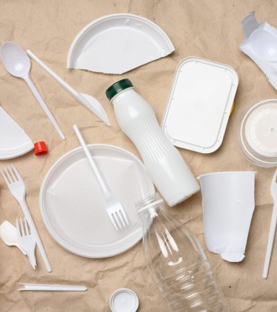 plastic waste from life on the background of brown kraft paper, environmental pollution, top view