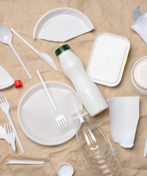 plastic waste from life on the background of brown kraft paper, environmental pollution, top view