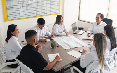 Professionals Discuss Engineering Projects 2024 05 27 02 06 31 Utc Person with vitiligo in a work environment. Business meeting and project planning at an engineering company. A business meeting at an engineering firm, where professionals discuss projects and delivery dates. Participants review blueprints, take notes, and analyze a whiteboard to make strategic decisions. The atmosphere is collaborative and focused on achieving set goals.