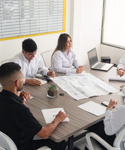 Professionals Discuss Engineering Projects 2024 05 27 02 06 31 Utc Person with vitiligo in a work environment. Business meeting and project planning at an engineering company. A business meeting at an engineering firm, where professionals discuss projects and delivery dates. Participants review blueprints, take notes, and analyze a whiteboard to make strategic decisions. The atmosphere is collaborative and focused on achieving set goals.