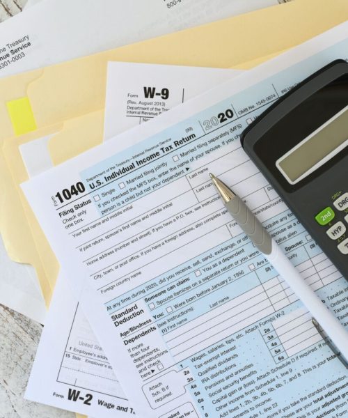 tax-forms-calculator-and-pen-on-wooden-surface-2026-01-08-22-54-41-utc