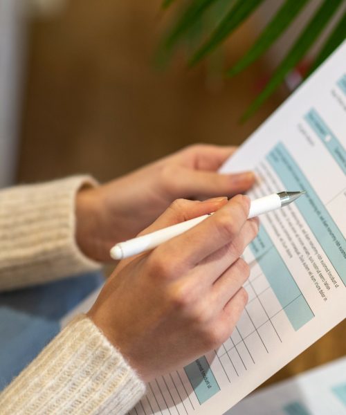 Paying taxes. A woman holding the paper for counting tax expences